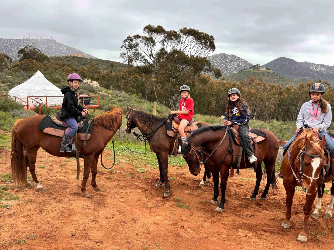 A guided horseback trail ride through a San Diego canyon at golden hour
